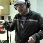 White guy, glasses, baseball hat, beard, making pancakes, rapping