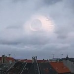 Death Star in blue sky and clouds above rooftops in Denmark