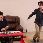 guy playing a red piano keyboard while another guy tap dances