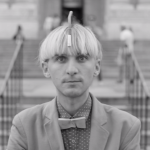 Black and white screen capture of Neil Harbisson syborg