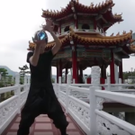 Guy performs contact juggling with a clear glass globe