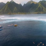 Boats in water surf around Tahiti