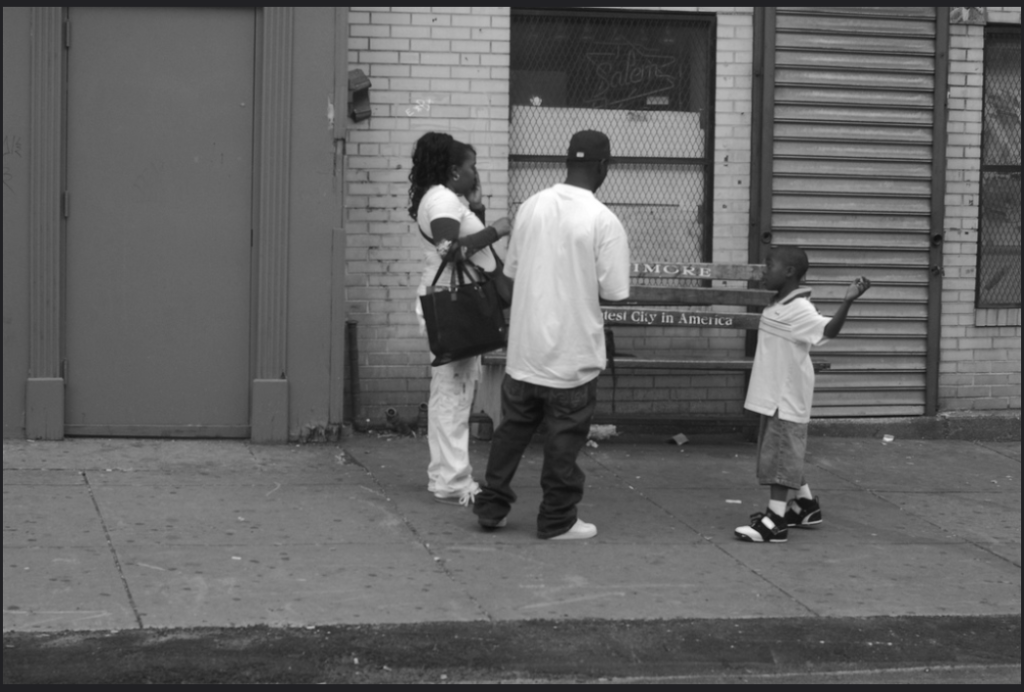 Baltimore family standing in front of a bench